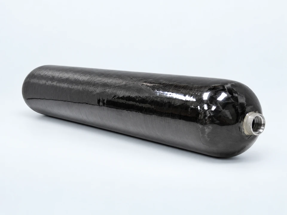 Orbit elongated carbon-composite pressure vessel with a threaded metal port, shown horizontally on a pale studio background; representative configuration.