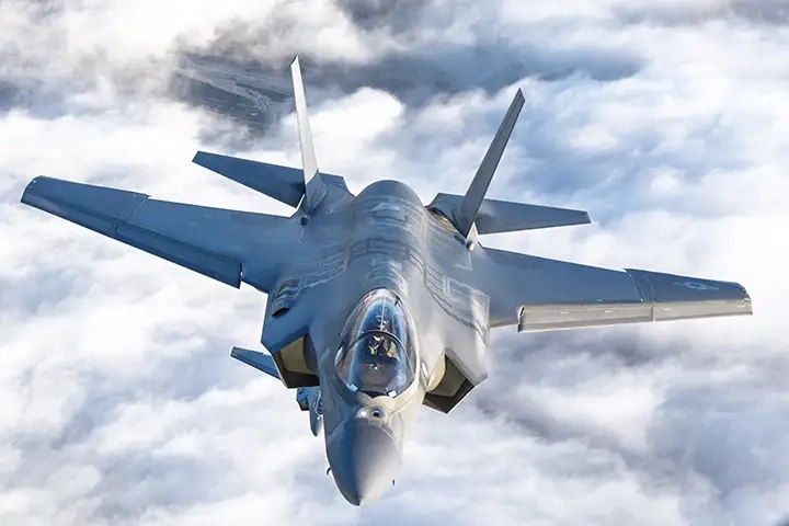 Supplied aircraft application image showing a jet in flight above clouds.
