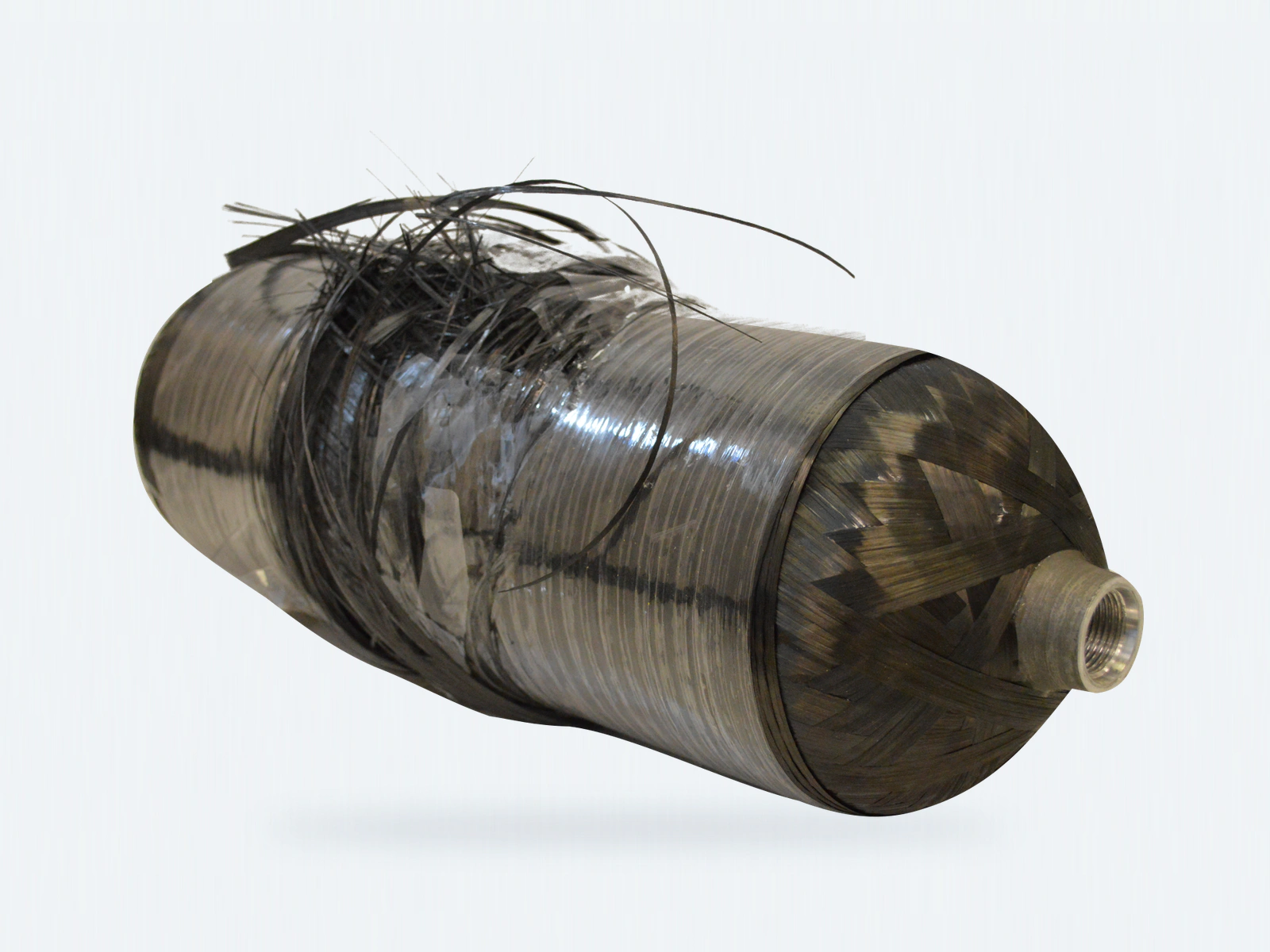 Composite pressure-vessel specimen after burst testing, showing the original ruptured overwrap, loose fibers and metallic end port.