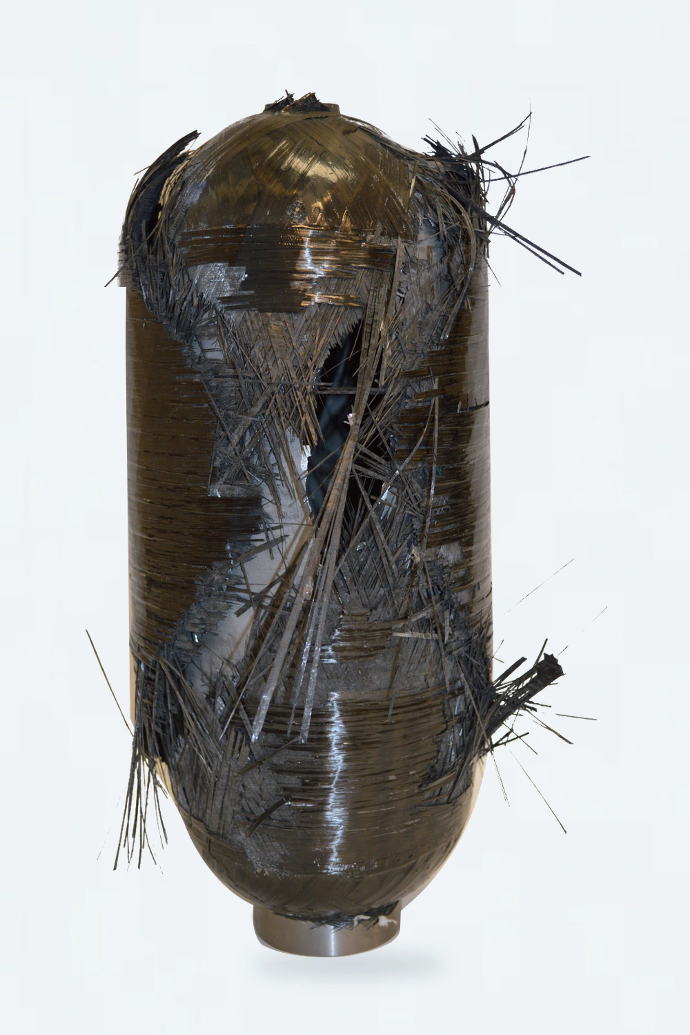 Upright composite specimen after burst testing, showing the original open rupture and separated reinforcement.
