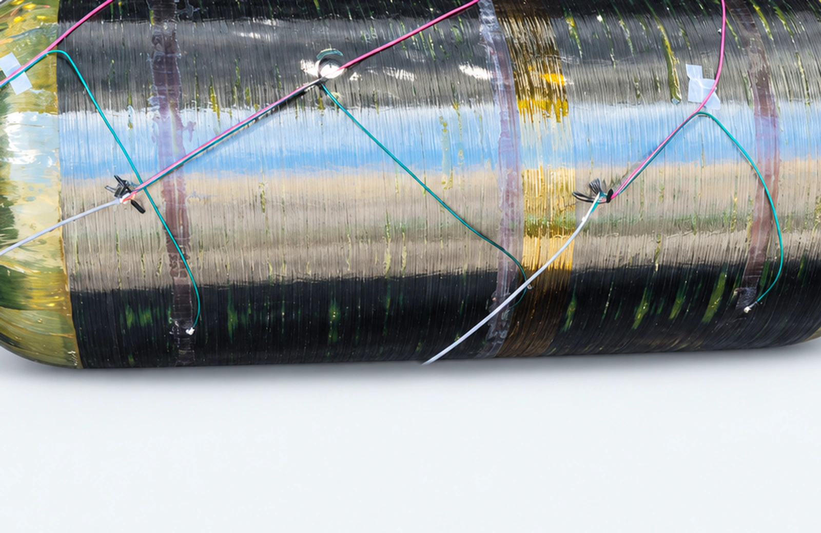 Detail of strain-gauge attachment points and sensor leads on the composite vessel surface.