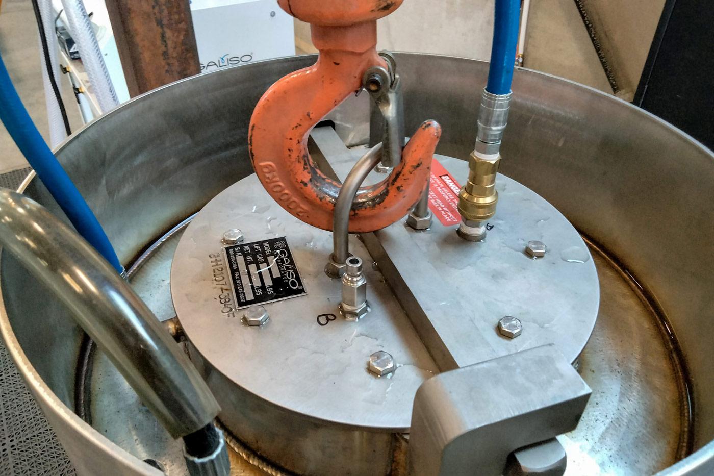 Close-up of a CNG cylinder undergoing hydrostatic testing in a water jacket proof chamber, representing Steelhead’s inspection and recertification services that keep legacy fuel systems compliant and fleet assets in service.