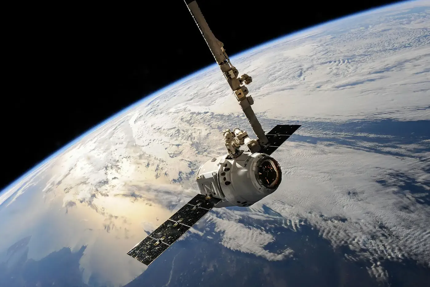 Steelhead Composites aerospace application showing a spacecraft in orbit above Earth, supported by high-integrity composite liners for propulsion, life-support, and other flight-critical systems.